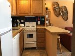 Full size fridge, compact stove in Kitchen